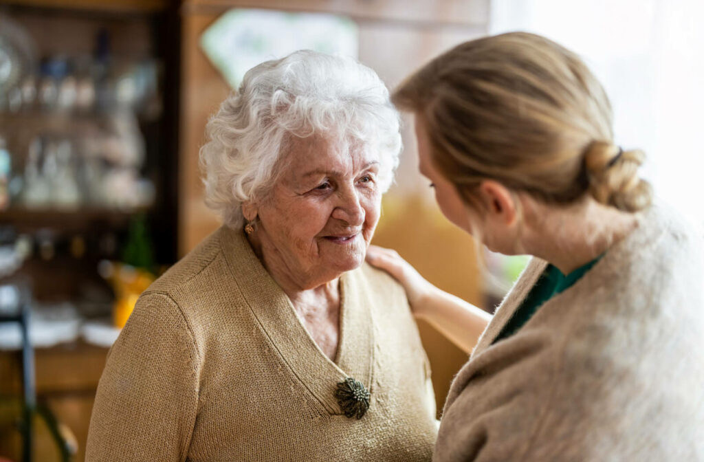 A daughter reassuring her senior mother that she will get taken care of in an assisted living facility. The daughter Emphasizes the positives and benefits of assisted living and the services it entails