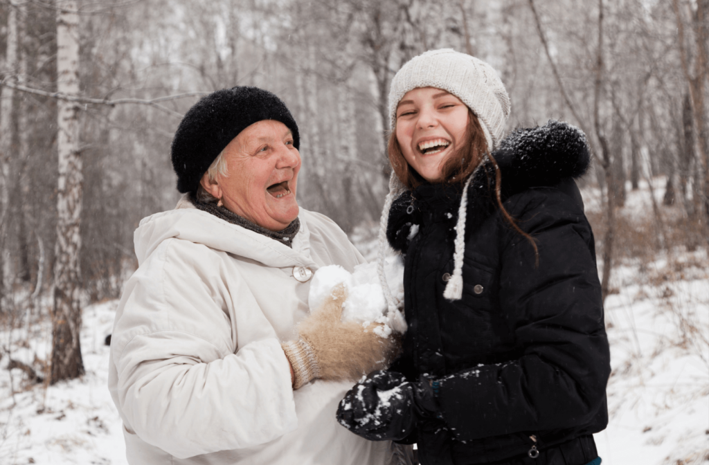Senior woman enjoying the snow with her grandchild.